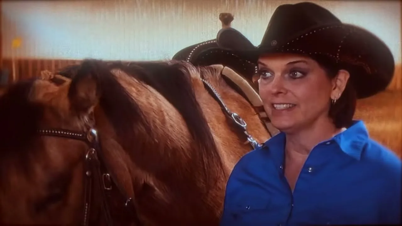 Rider standing beside her horse